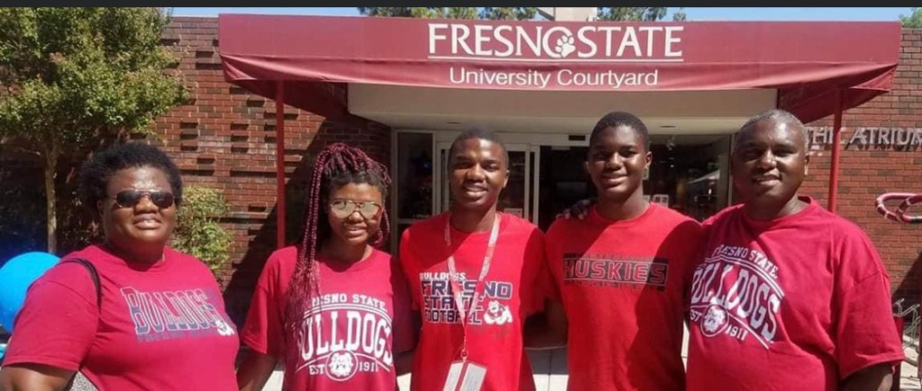 tim and his family stand in front of the dorms on move in day