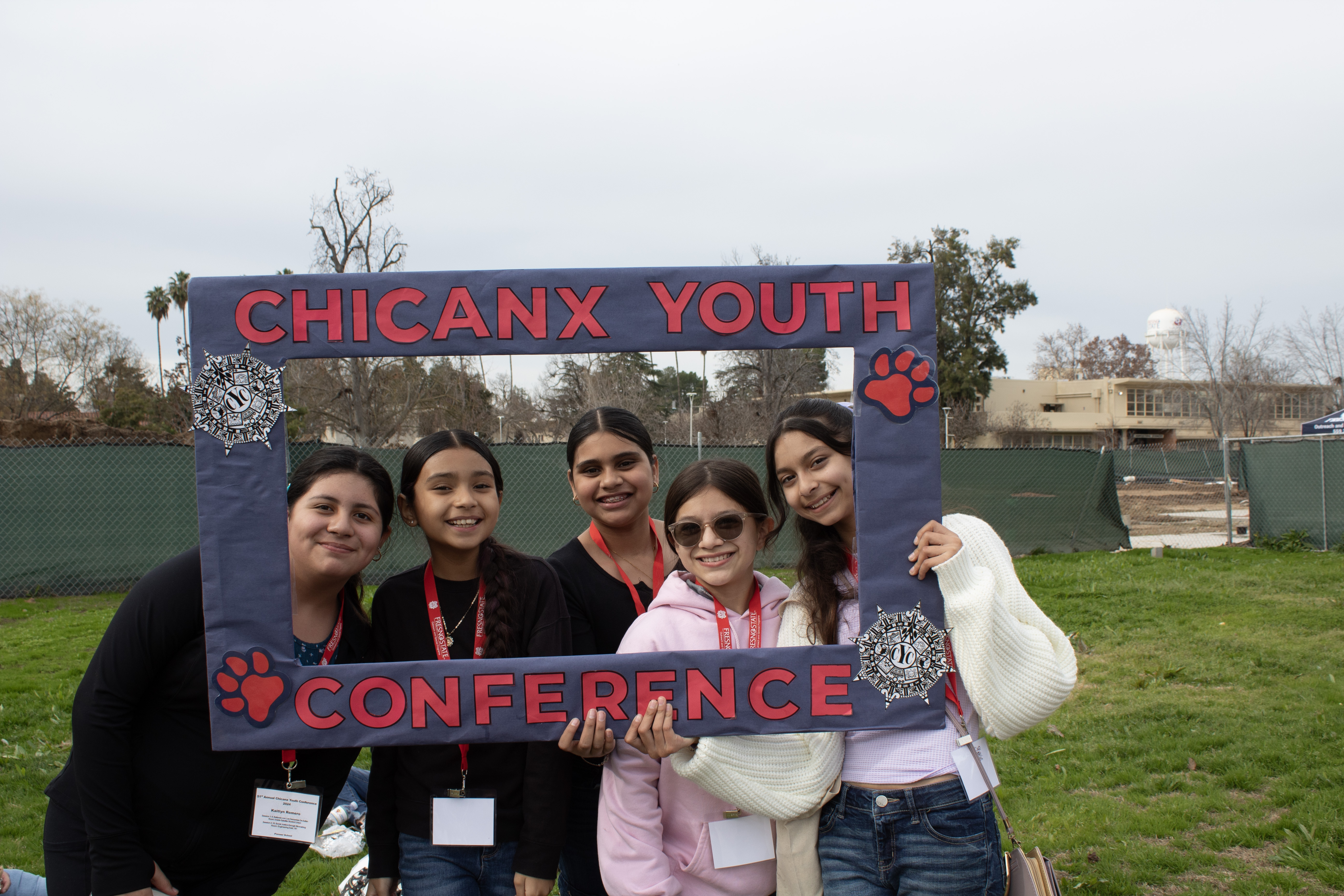 students holding a sign that reads "chicanx youth conference"