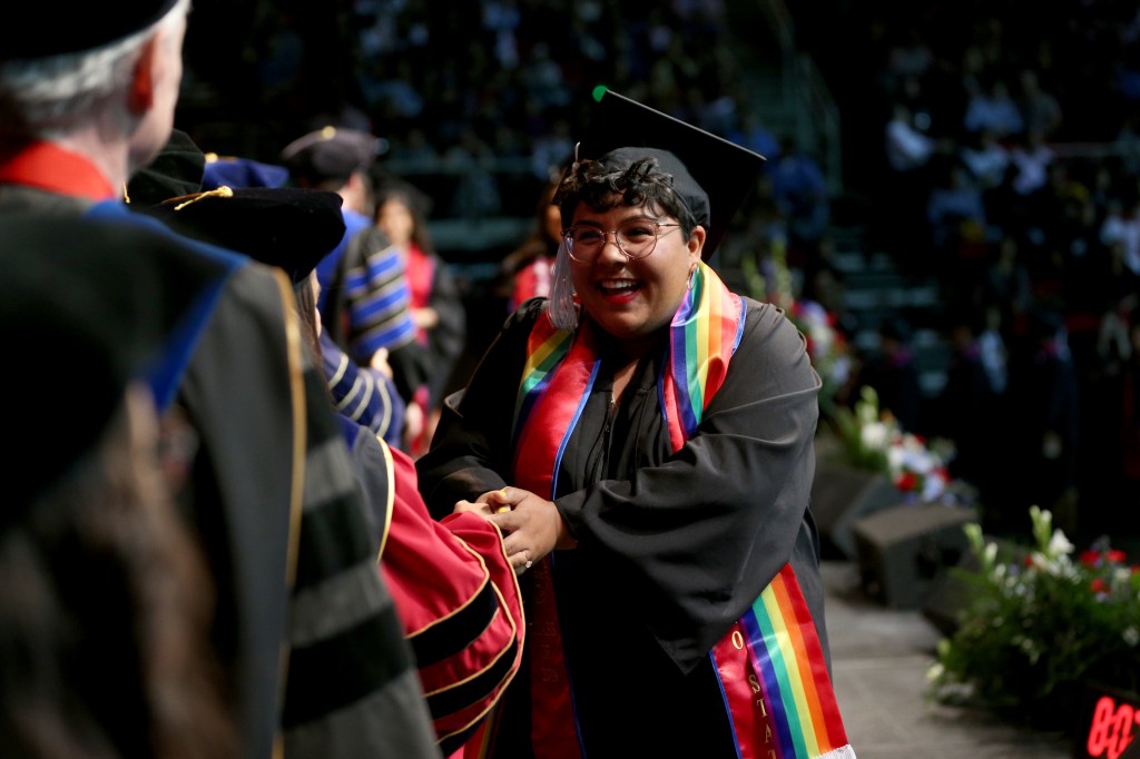 student in graduation regalia